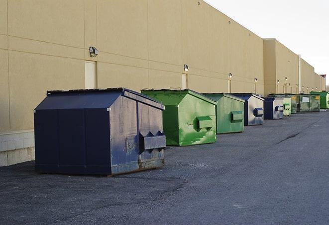 a fleet of red and blue construction dumpsters available for use in New River VA